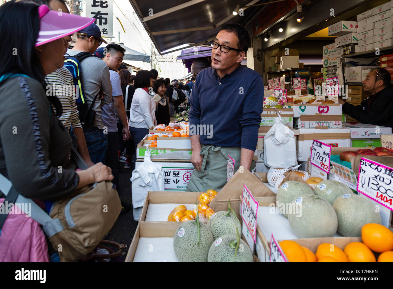 Tokyo, Japan - July 17, 2019 : japanese man selling fresh melon, persimmon, apple at the stall in the local fruit market in Tokyo, Japan. Stock Photo