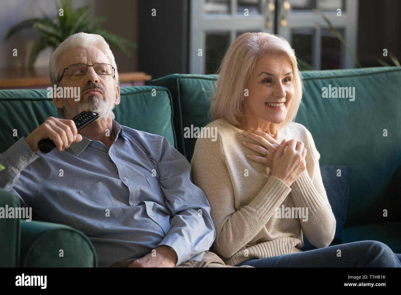 Aged couple, wife and husband watching tv show, series together Stock Photo