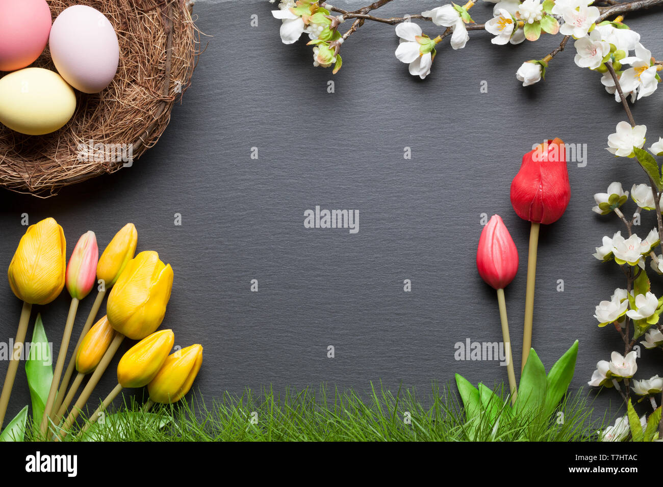 Happy easter background with colorful easter eggs and flowers Stock Photo