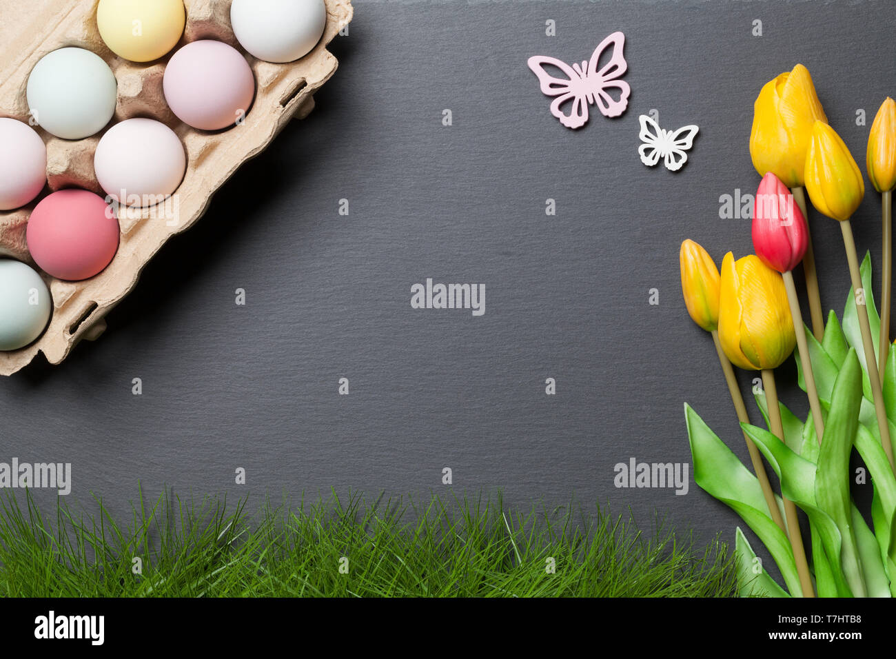Happy easter background with colorful easter eggs and tulips Stock Photo