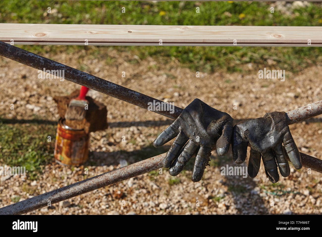 Used work gloves and paintbrush.Construction concept. Stock Photo