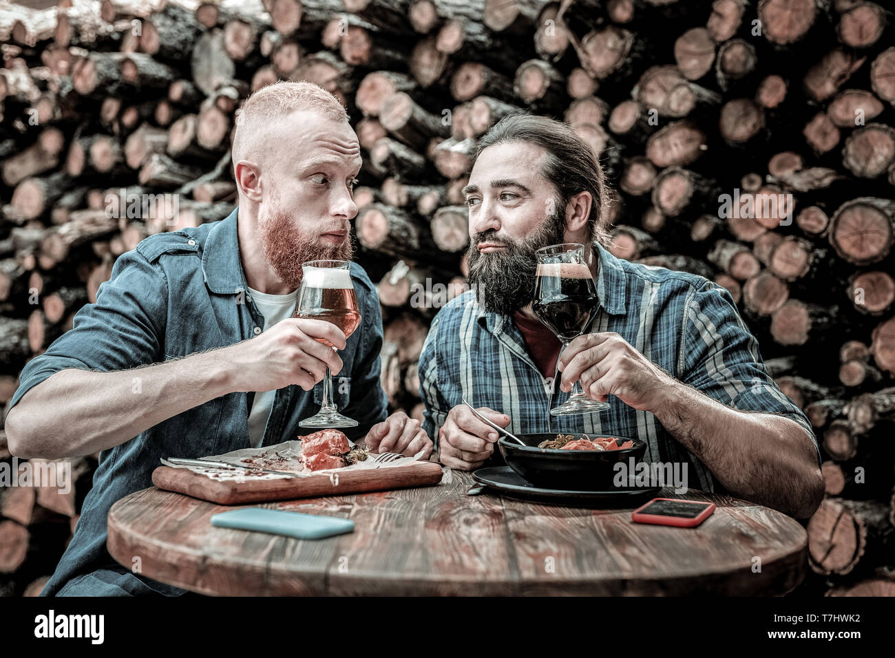 Friends raising their glasses and proposing a toast. Stock Photo