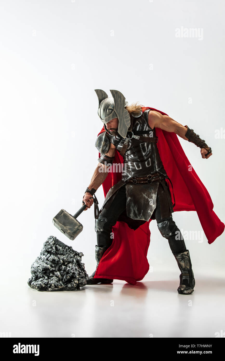Long hair and muscular male model in leather viking's costume with the big  hammer cosplaying Thor isolated on white studio background. Full-lenght  portrait. Fantasy warrior, antique battle concept Stock Photo - Alamy
