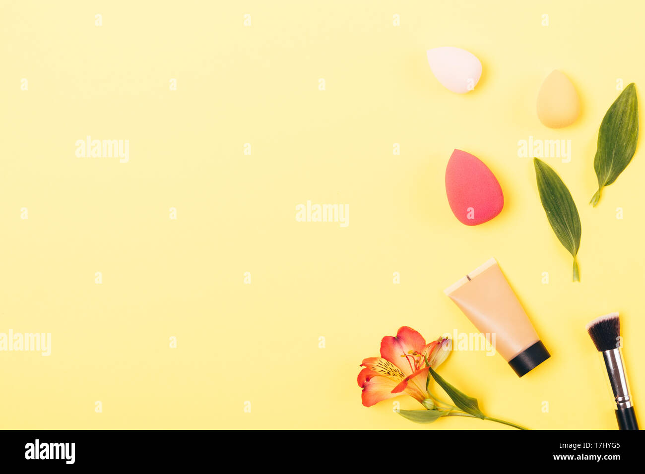 Foundation in tube next to tools for professional makeup synthetic