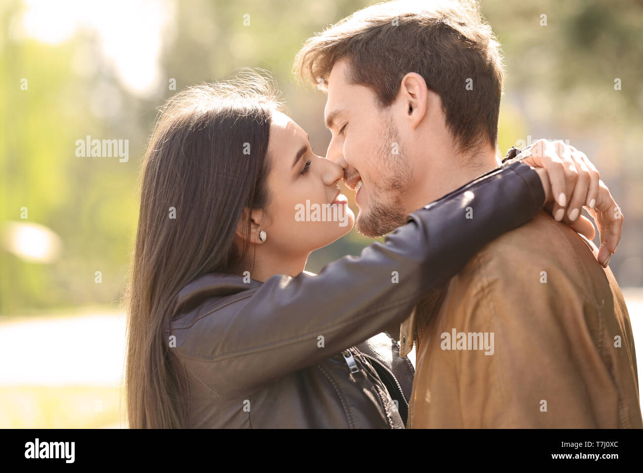 Young lovely couple kissing outdoors Stock Photo