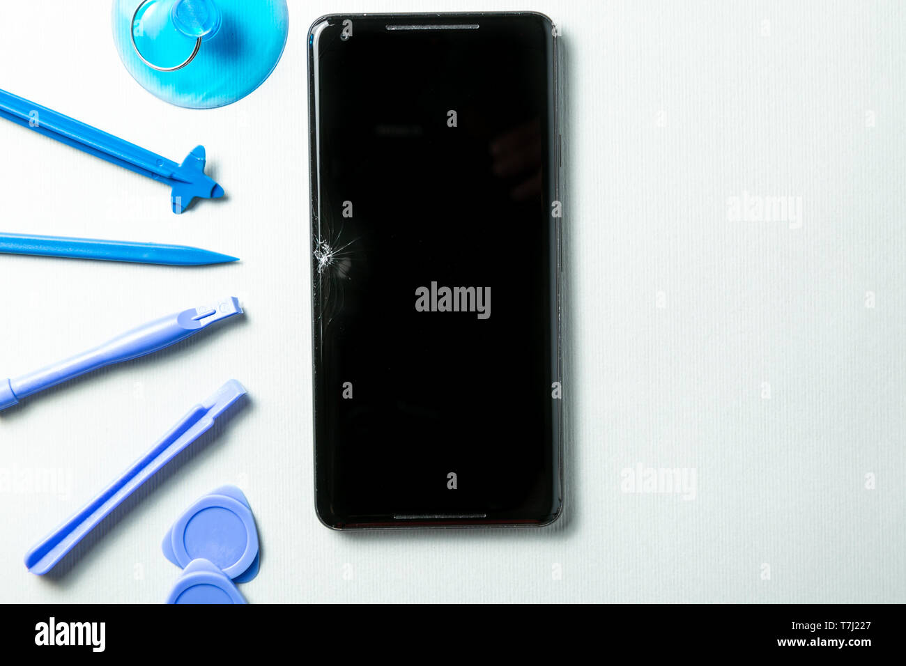 Broken phone with tools for repair, service concept Stock Photo