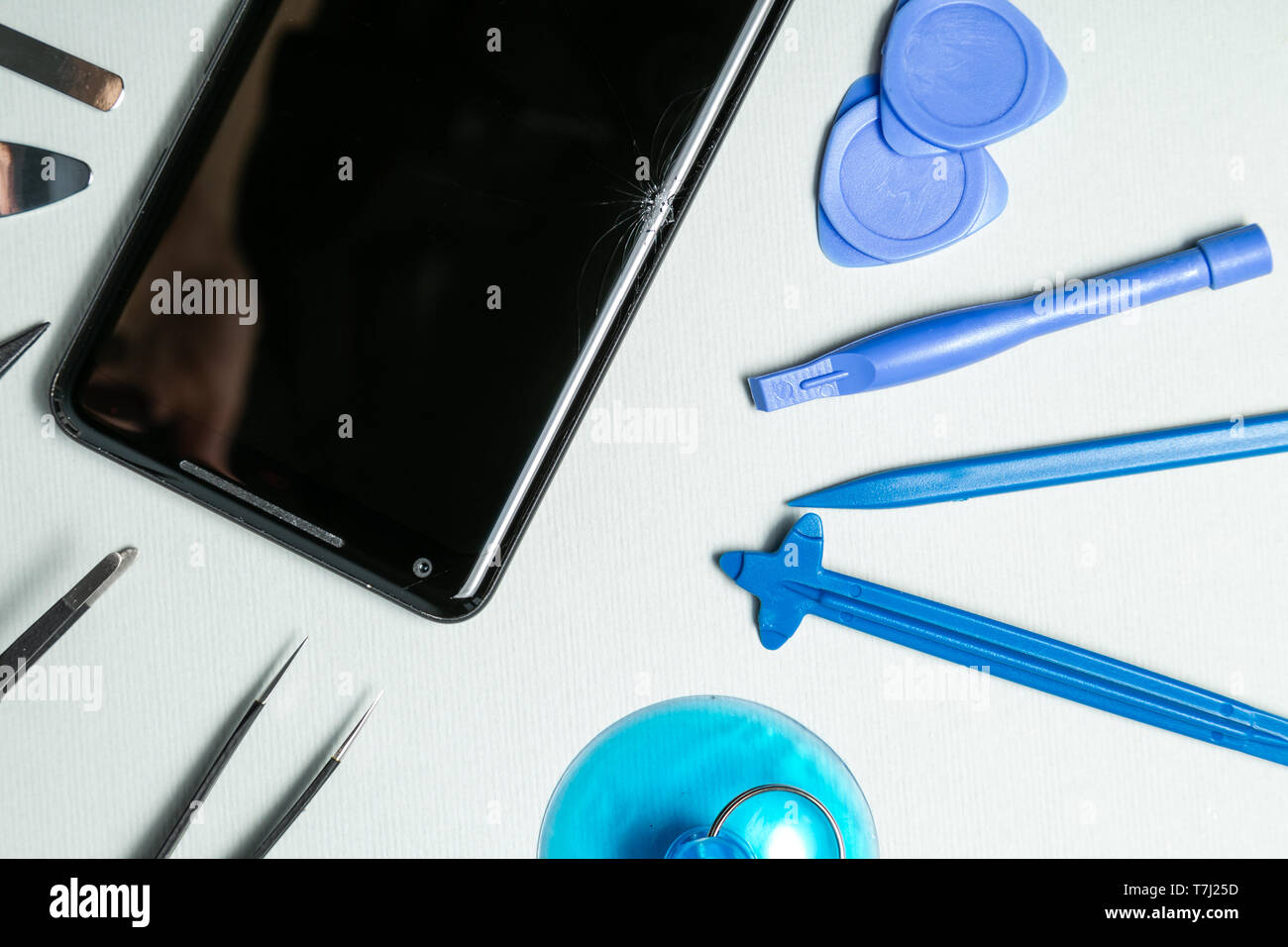 Broken phone with tools for repair, service concept Stock Photo