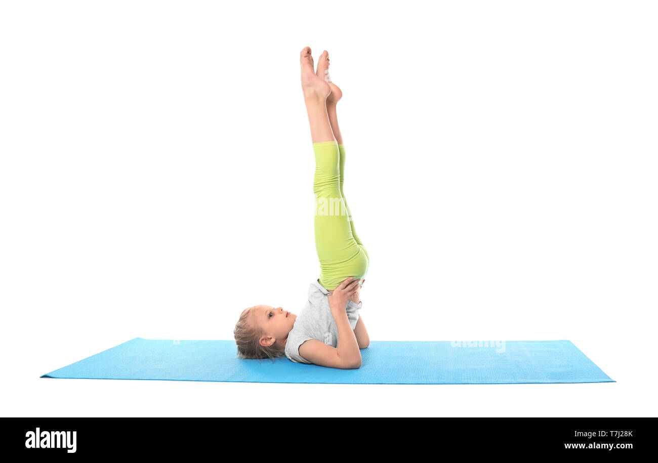 Little girl practicing yoga on white background Stock Photo - Alamy