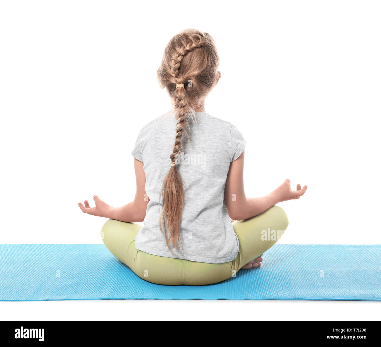 Little girl practicing yoga on white background Stock Photo - Alamy