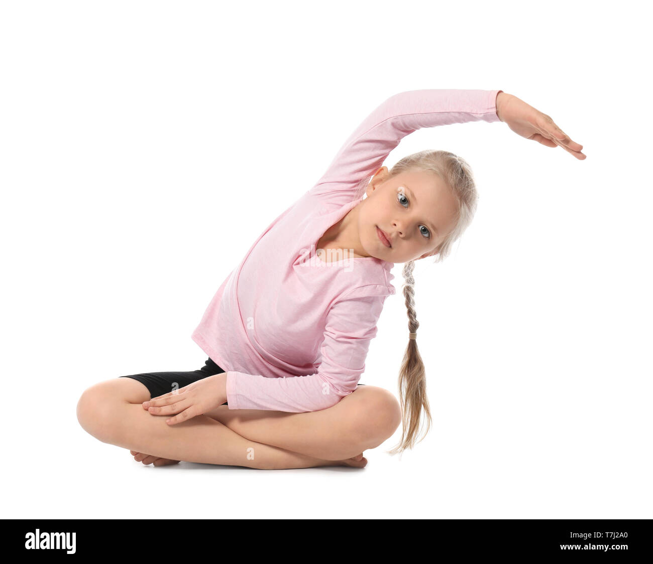 Little girl practicing yoga on white background Stock Photo - Alamy