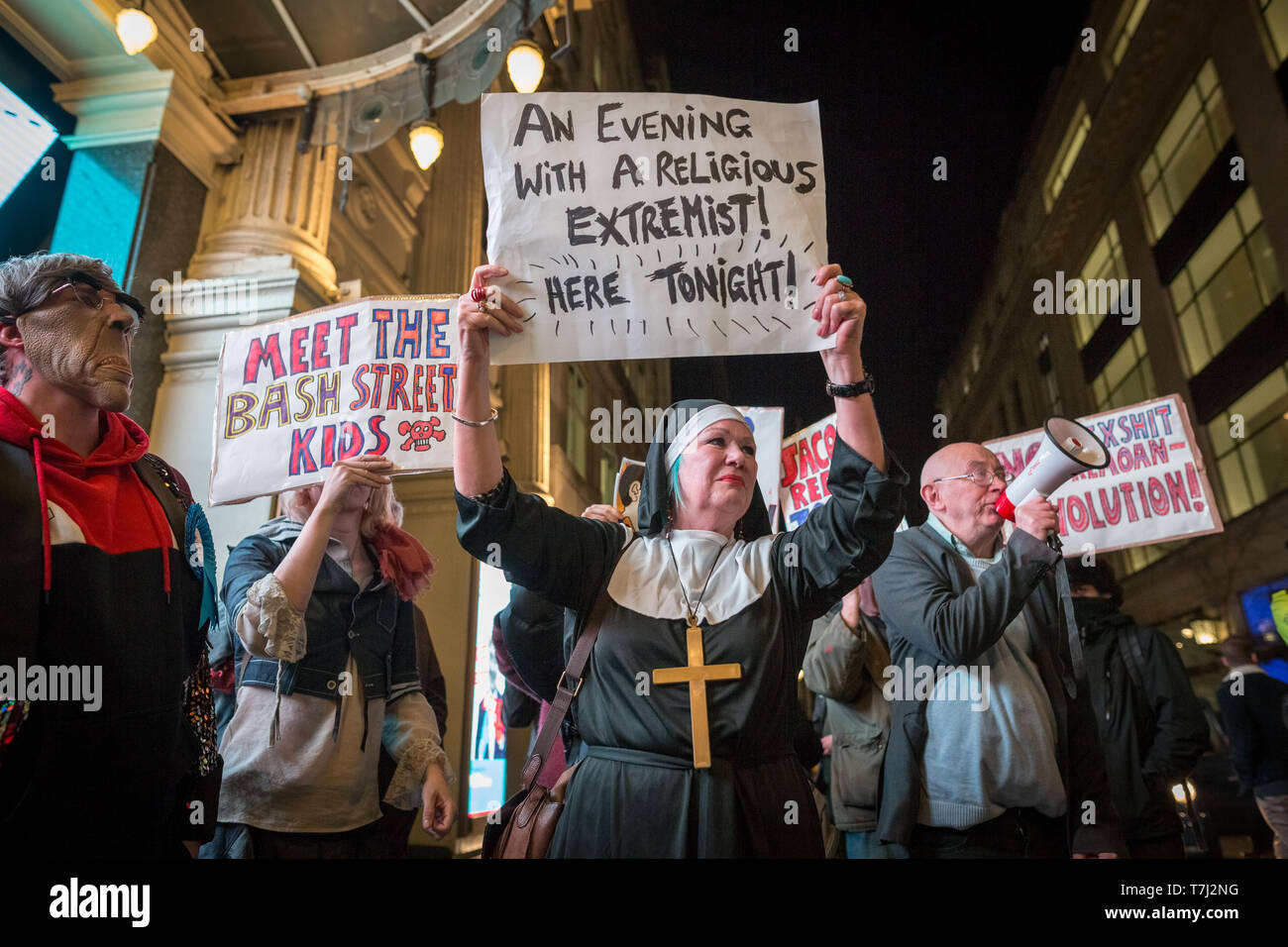 Protesters from Class War anarchist group hold a lively demonstration outside the London Palladium theatre against the evening talk featuring Jacob Rees-Mogg, Conservative MP and prominent Brexit supporter. Class War members, including long-time anarchist, Ian Bone (with megaphone), Jane Nicholl (dressed as a nun) and Adam Clifford (left, as Rees-Mogg parody) claim Mr Rees-Mogg, a Catholic, is a religious extremist because of his outspoken views on abortion. London, UK. Stock Photo