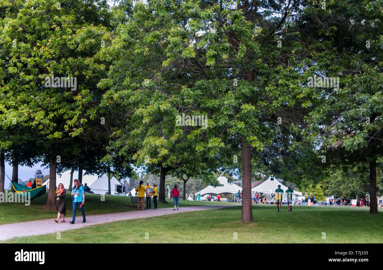 Attendees walk through Jericho Beach Park during the Vancouver Folk Festival in British Columbia, Canada Stock Photo