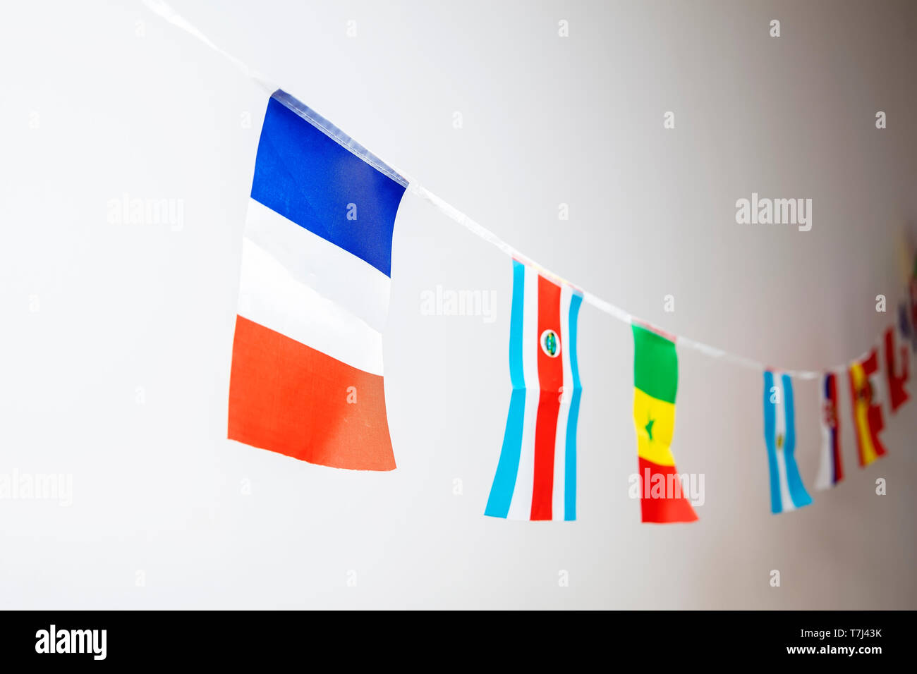 Triangle flags of various countries hanging on the rope Stock Photo - Alamy
