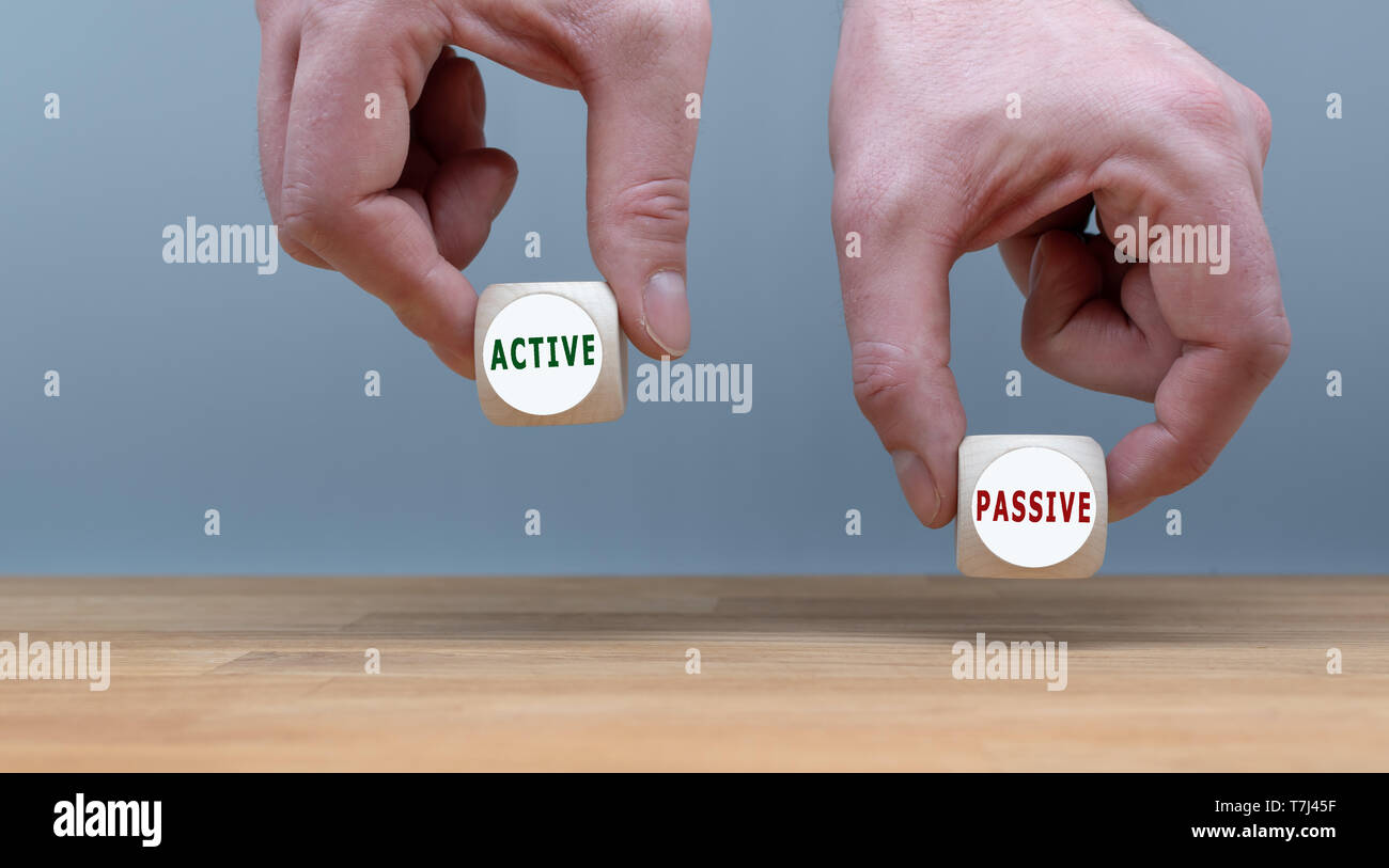 Being active or passive? Two Hands hold two dice with the words 