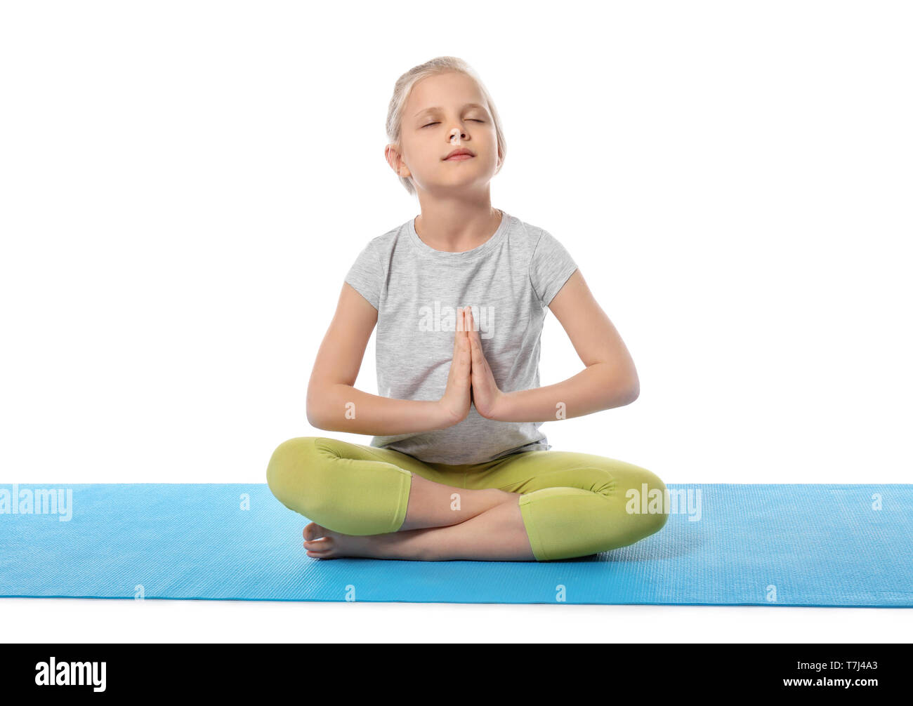Little girl practicing yoga on white background Stock Photo - Alamy