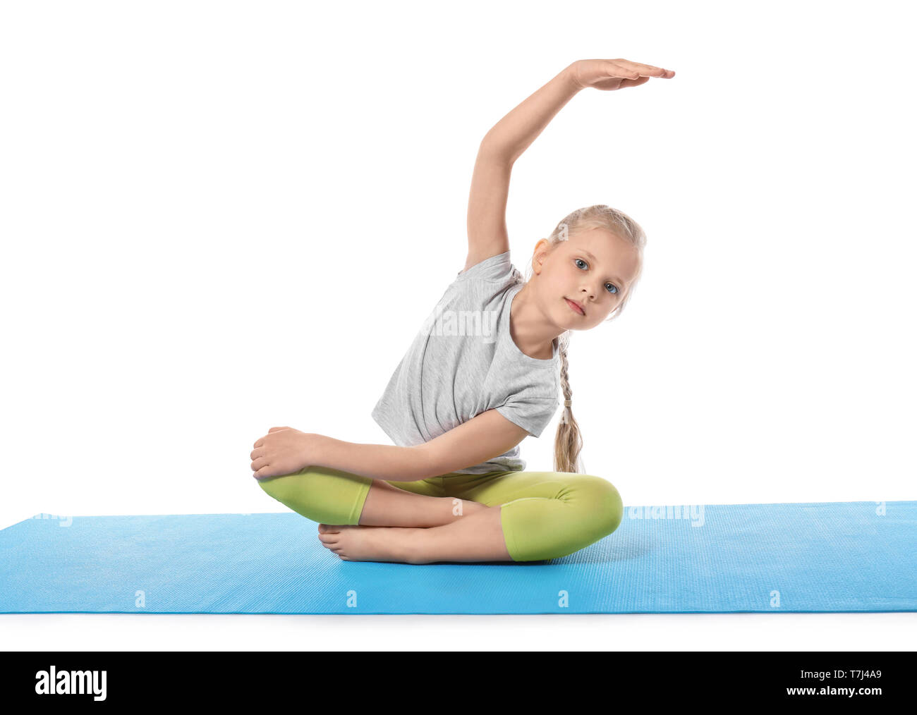 Little girl practicing yoga on white background Stock Photo - Alamy
