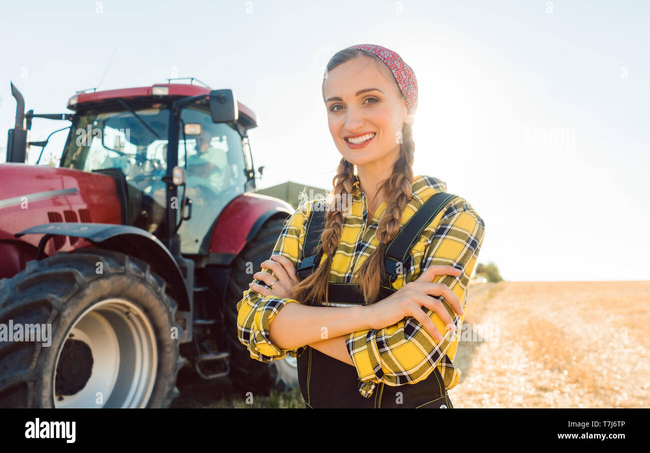 Farmer woman driving a tractor Stock Photo - Alamy