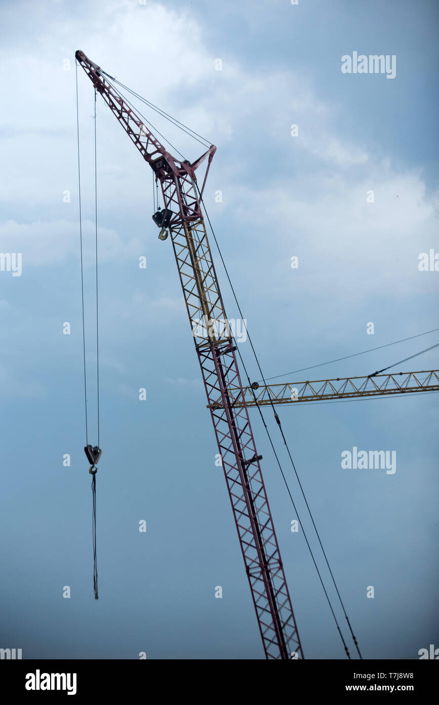 Crane on construction site on cloudy blue sky background Stock Photo ...