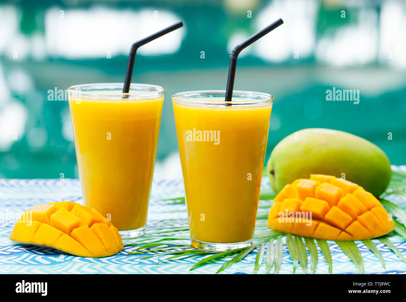 Fresh tropical fruit smoothie mango juice and fresh mango on a outdoor  tropical background Stock Photo - Alamy