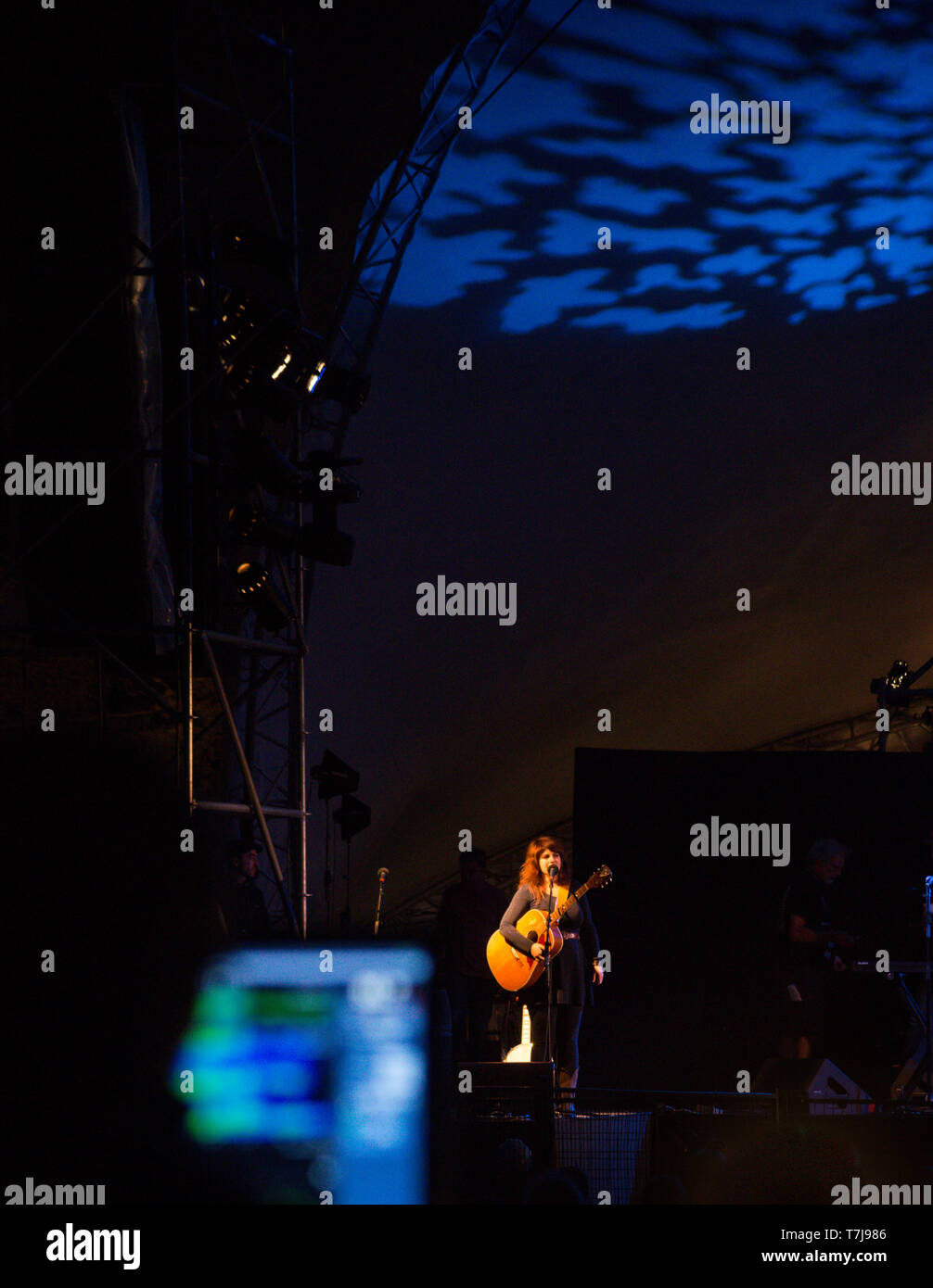 Singer songwriter Lisa LeBlanc performs at the Regina Folk Festival in Saskatchewan, Canada, viewed from behind the sound board at the main stage Stock Photo