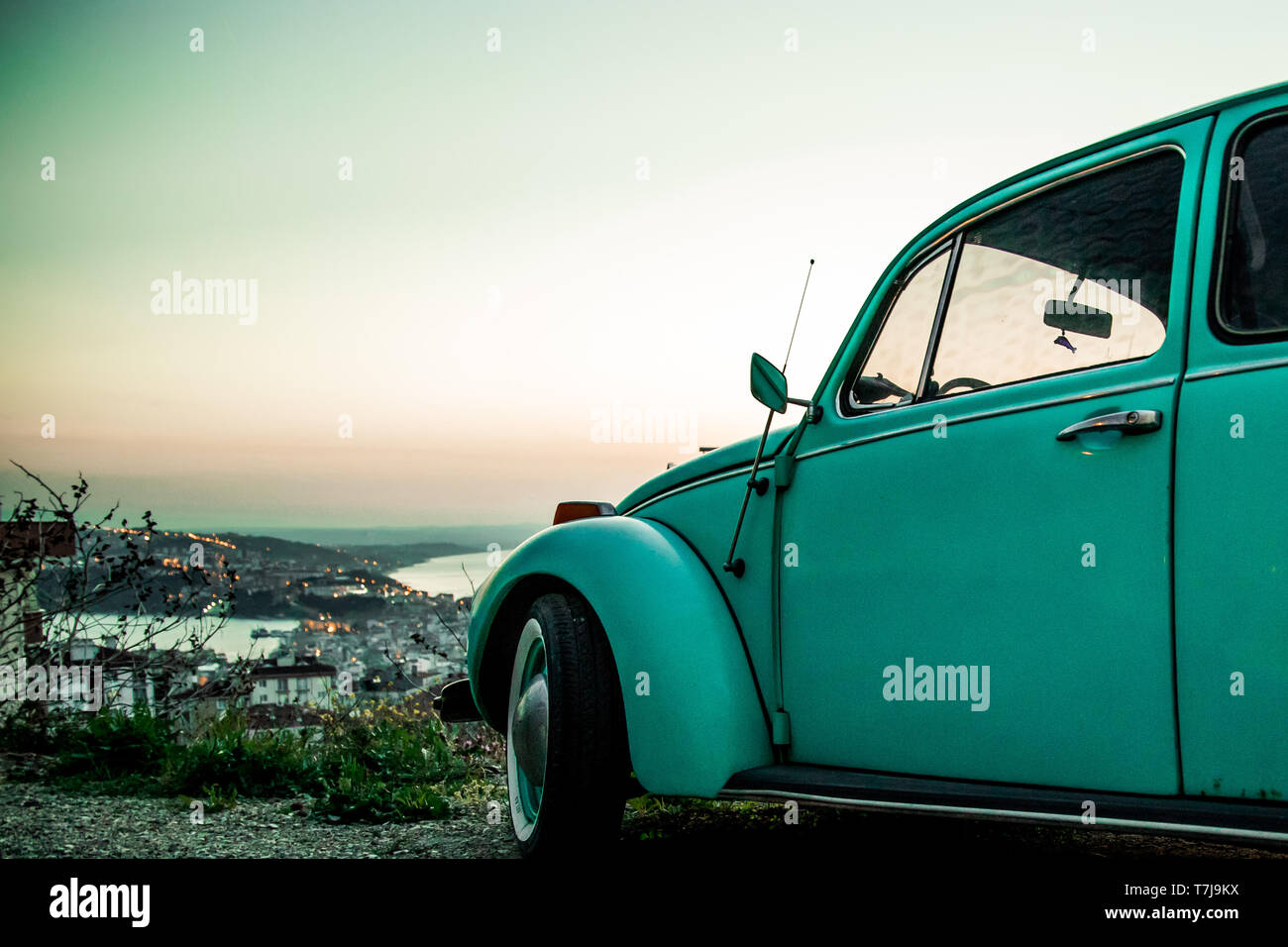 vintage beetle car at sunset, to make a road trip millennial Stock Photo