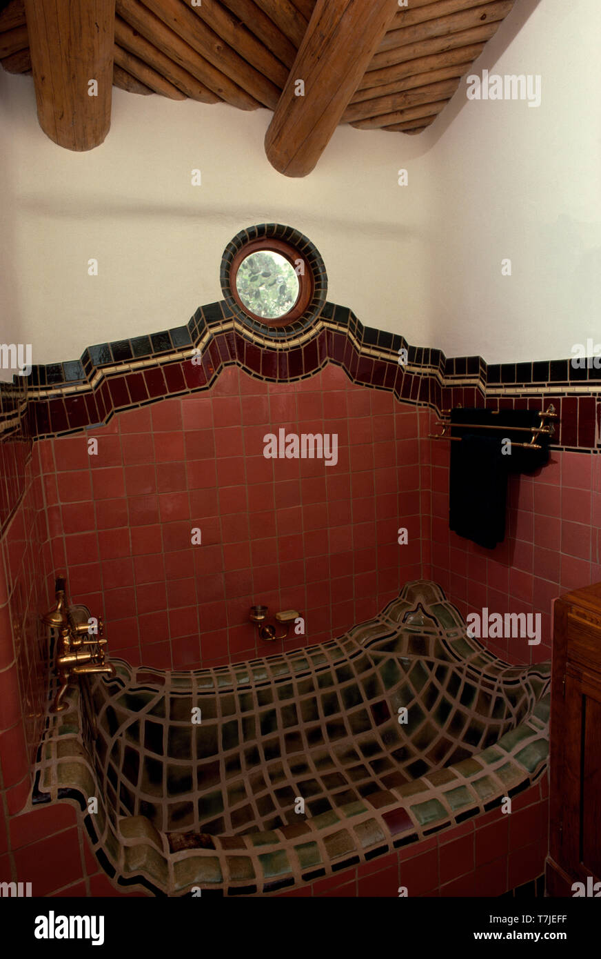 Irregular shaped bath lined with ceramic tiles Stock Photo