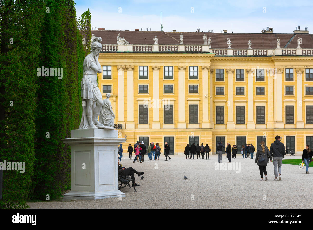 Schonbrunn garden, view of people walking along a tree-lined path in the gardens of the Schloss Schönbrunn in Vienna, Austria. Stock Photo
