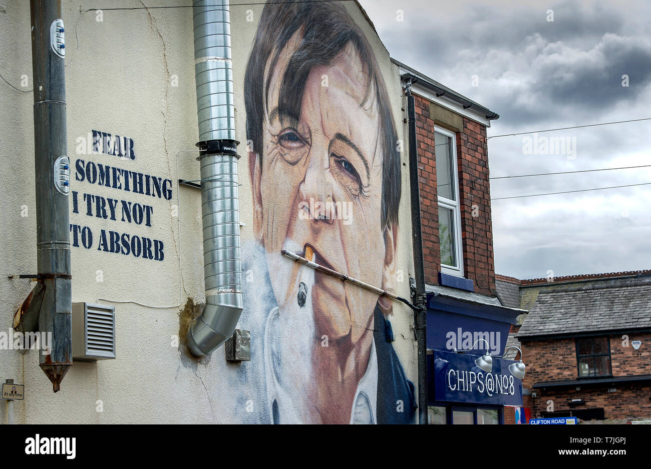 Mural of legendary Prestwich, Manchester singer and songwriter Mark E Smith of the group The Fall, on the wall of the Chips@No8 fish and chip shop in  Stock Photo