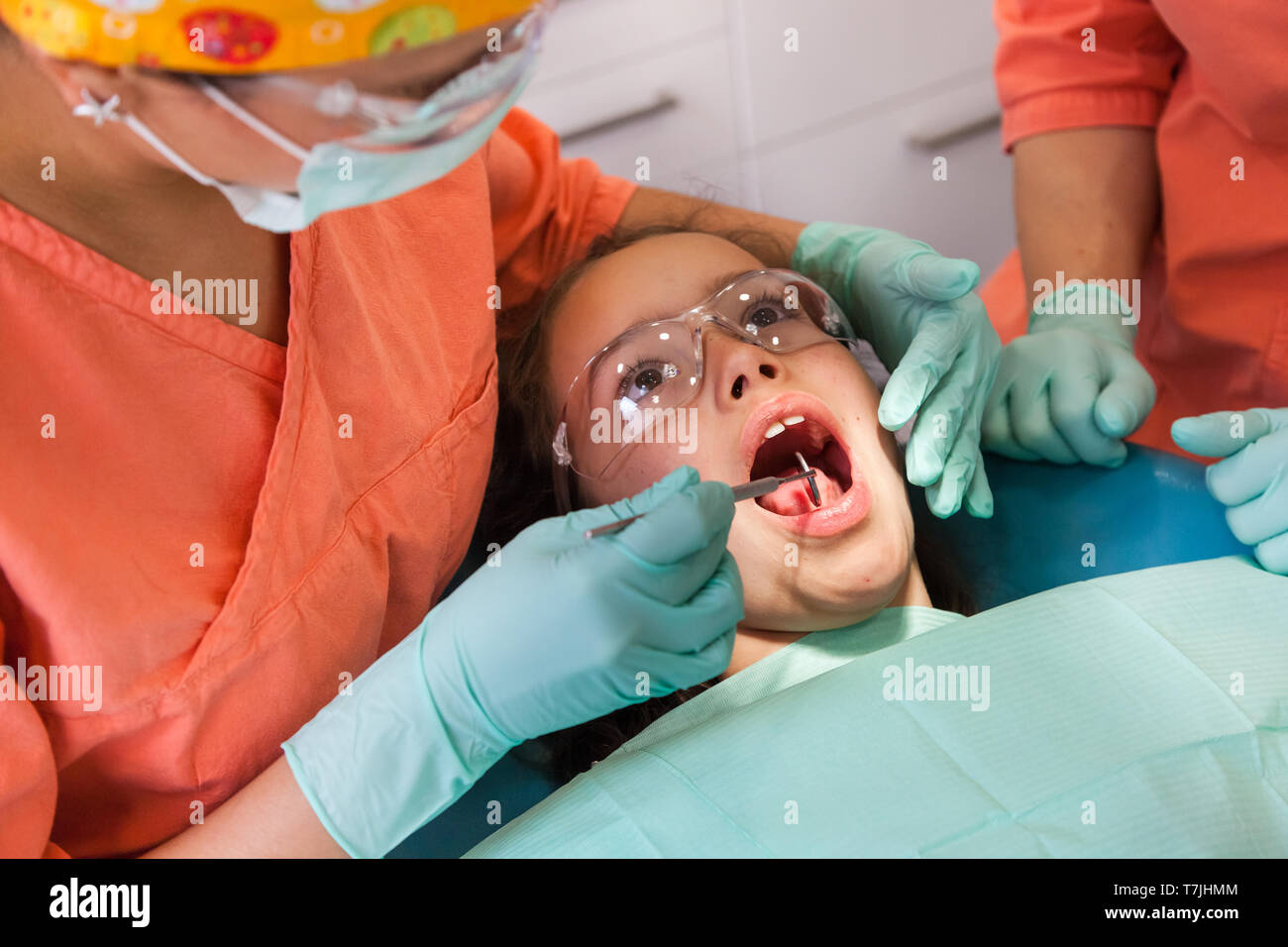 Pretty 10-year-old girl at the dentist, examination with dentist tools Stock Photo