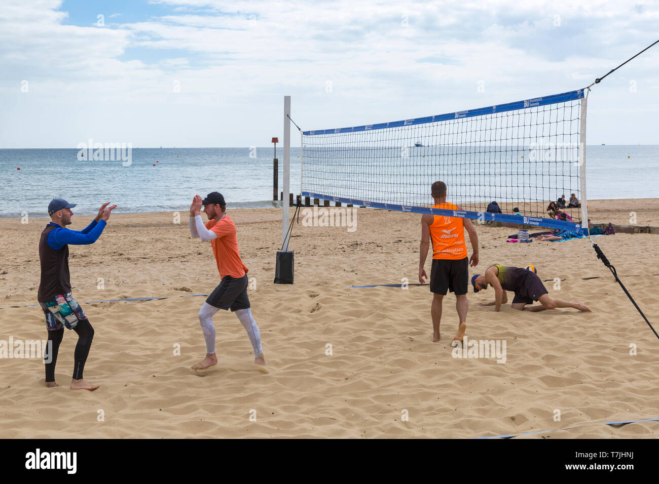 Beach volleyball players at Boscombe Beach, Bournemouth, Dorset UK in May Stock Photo