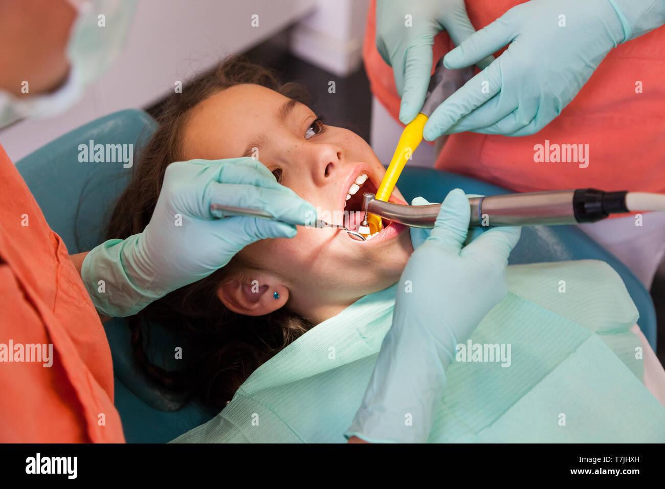 Pretty 10-year-old girl at the dentist, examination with dentist tools Stock Photo