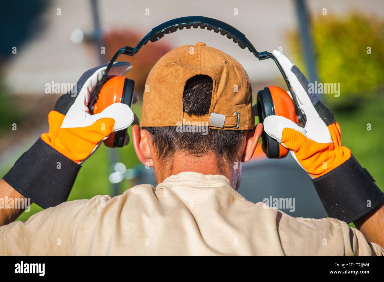 Worker Wearing Noise Reduction Ear Muffs. Loud Noises Job. Stock Photo