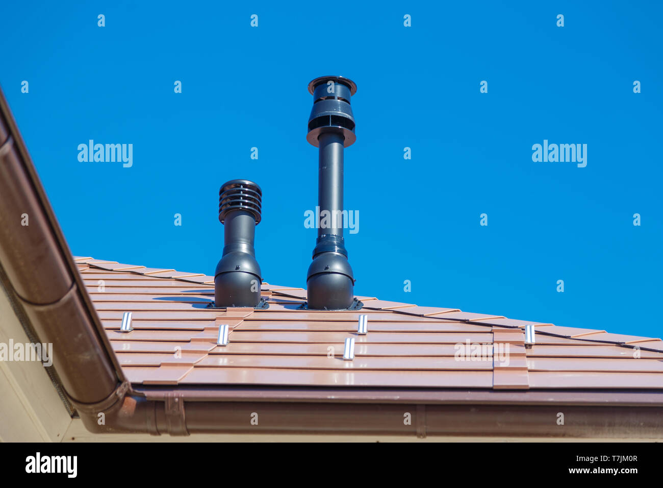 Exhaust pipe on the private house roof Stock Photo Alamy