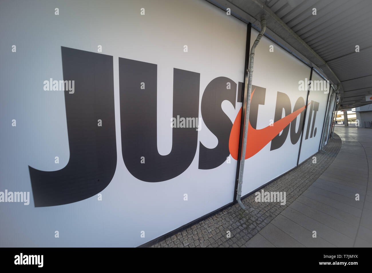 The Nike logo and Nike motto "just do it" on the window display in an  outlet in Wolfsburg, Germany, April 20, 2019 Stock Photo - Alamy