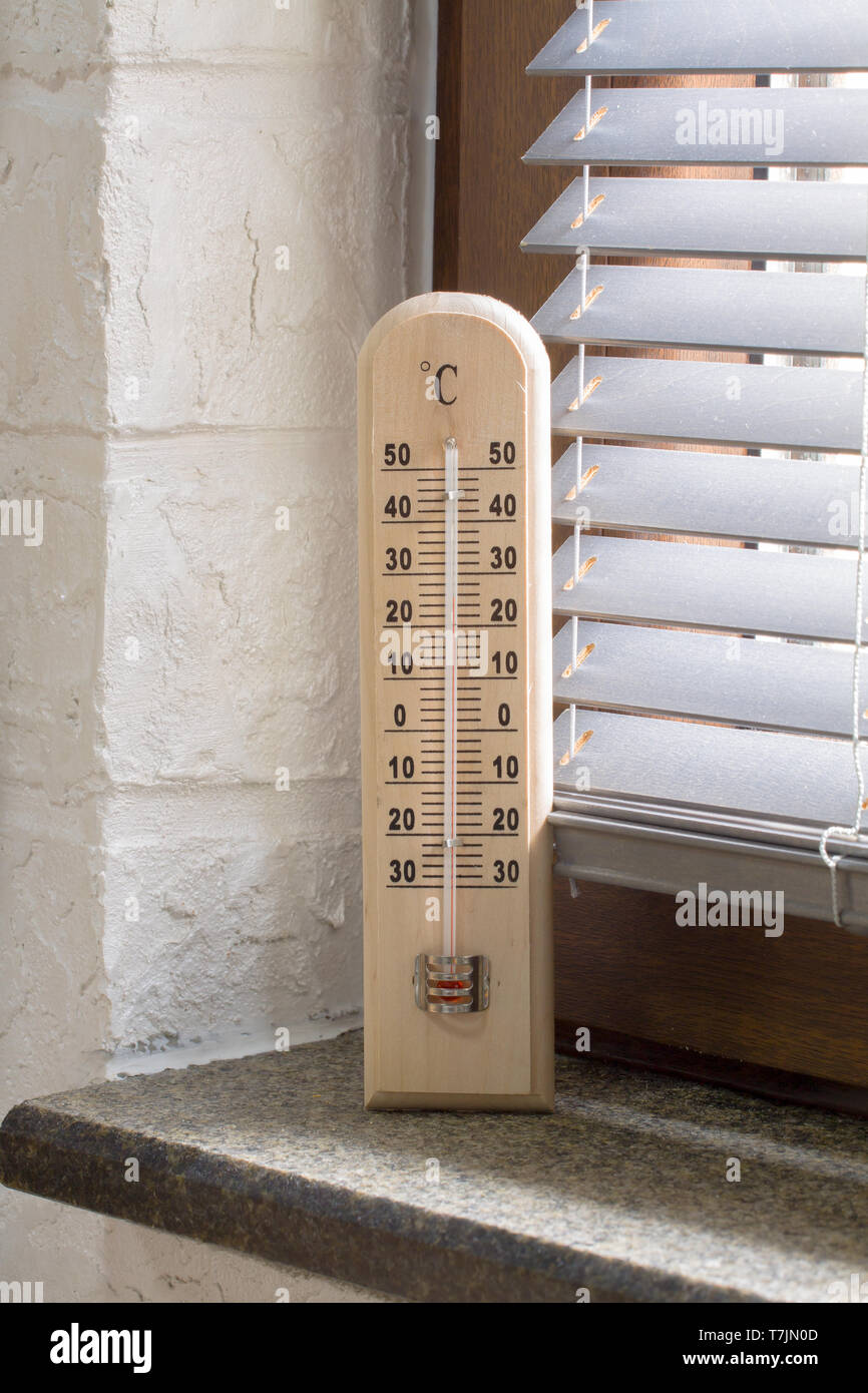 https://c8.alamy.com/comp/T7JN0D/a-wooden-thermometer-with-an-analog-scale-measuring-the-temperature-placed-near-the-window-T7JN0D.jpg