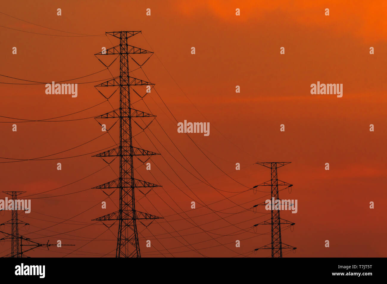 High voltage electric pole and transmission lines in the evening ...