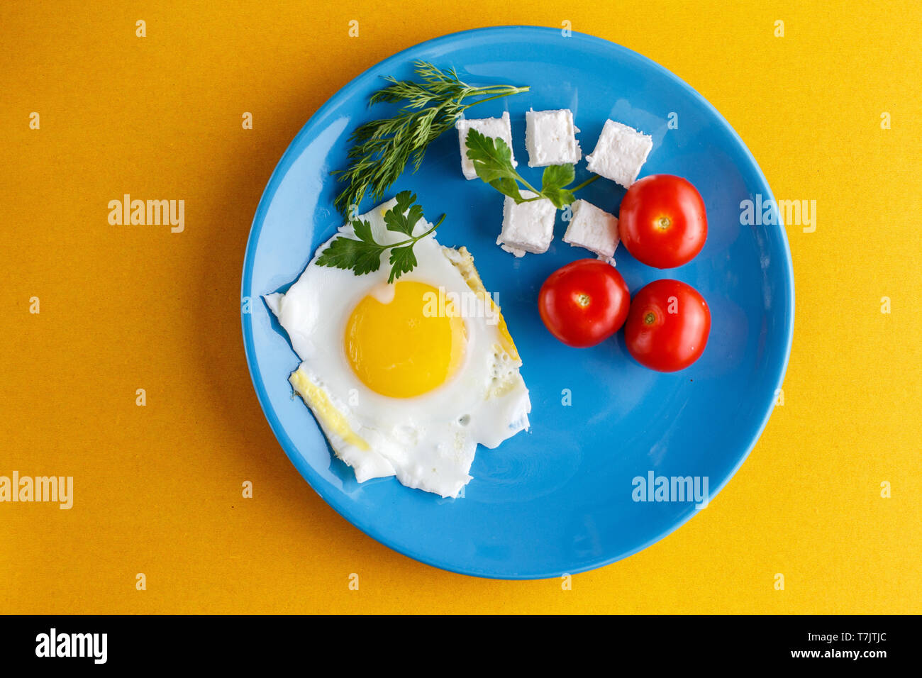 Turkish Breakfast on a blue plate on a bright yellow background Stock Photo