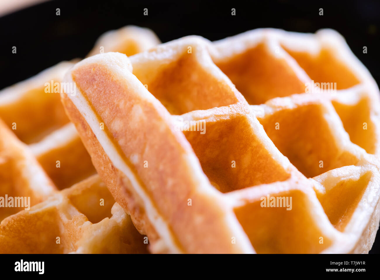 woman hands prepare waffle for serving process.waffle made from dough