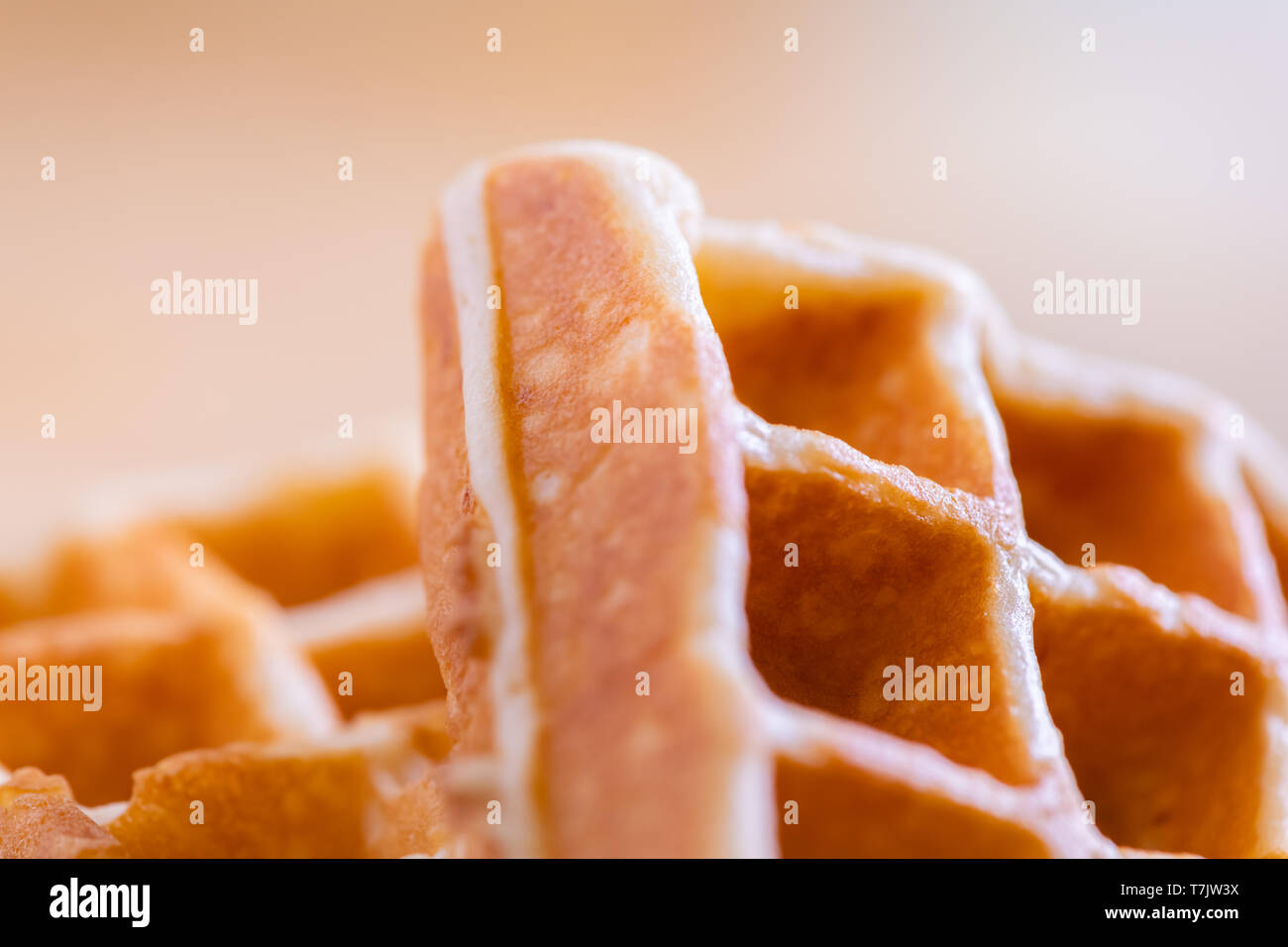 woman hands prepare waffle for serving process.waffle made from dough