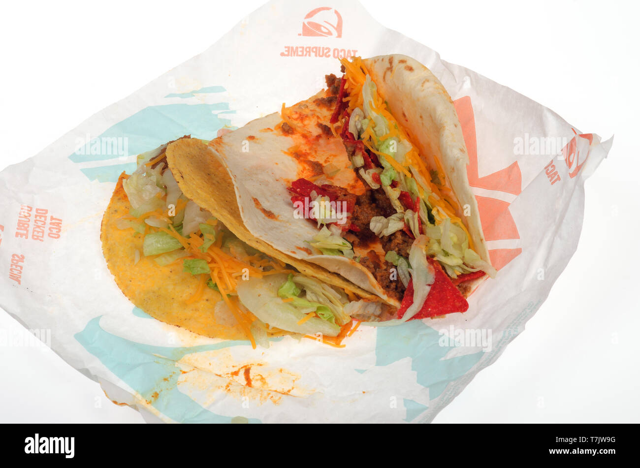 2 Taco Bell tacos on wrapper, 1 Crunchy Taco hard shell and 1 Loaded Nacho Taco spicy soft shell on wrapper Stock Photo