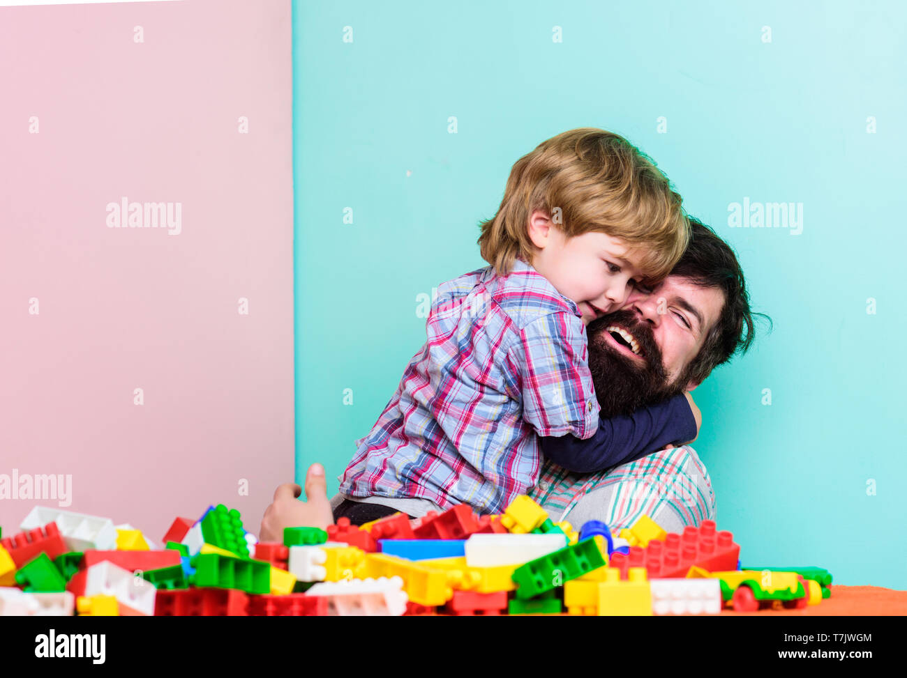 My family. father and son play game. small boy with dad playing together. happy family leisure. child development. building home with colorful constructor. I prepared surprise for you. i love you. Stock Photo