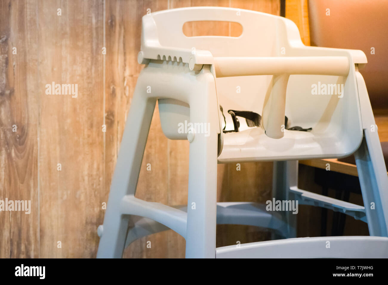 high chair seat for sit eating position for kids in fast food.use baby chair seat for safe cute child in cafe breakfast.high chair seat have guard for Stock Photo