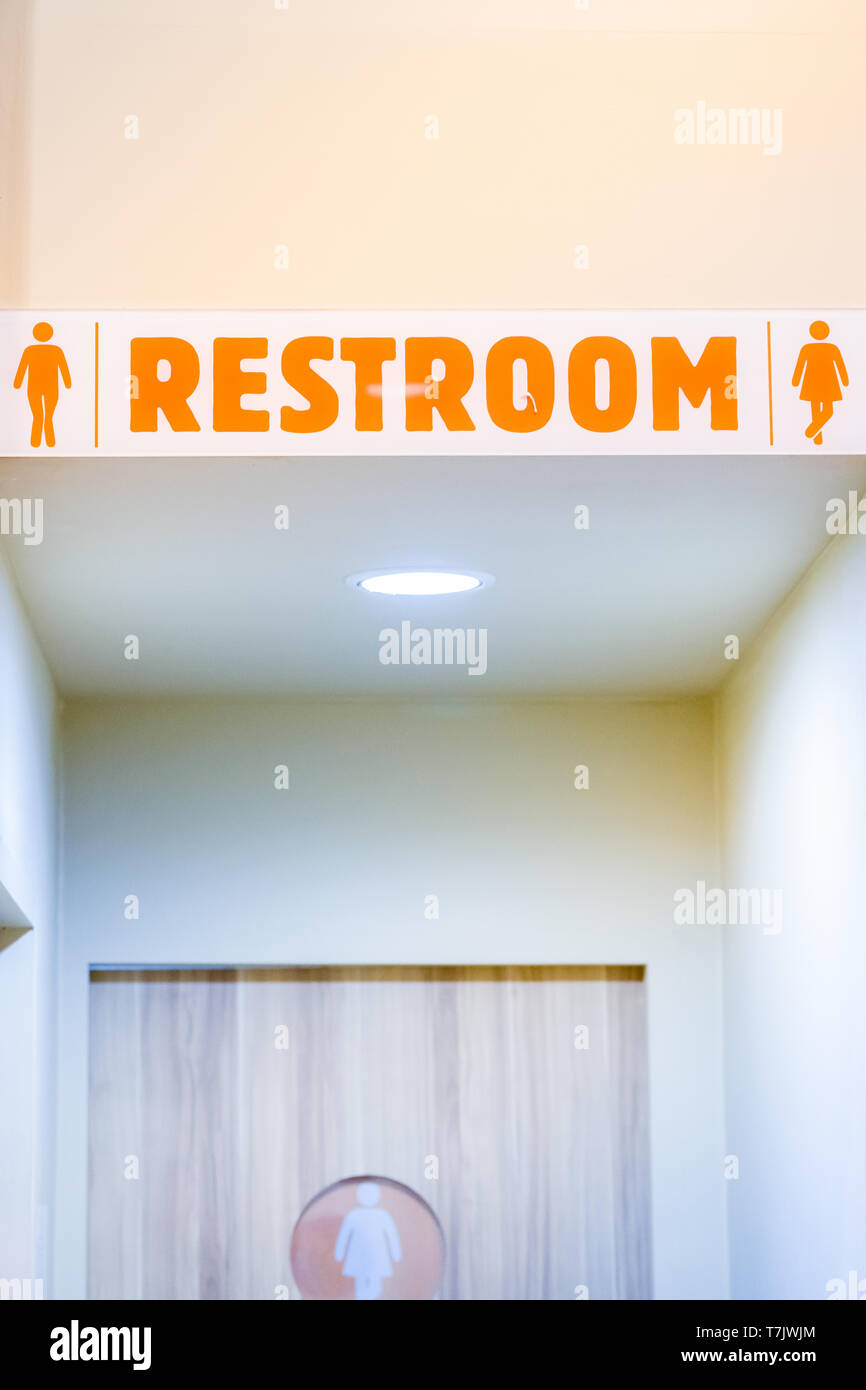 man and woman use toilet after delicious meal in fast food.clean lavatory in restaurant.acrylic toilet restroom sign in coffee shop cafe.male and fema Stock Photo