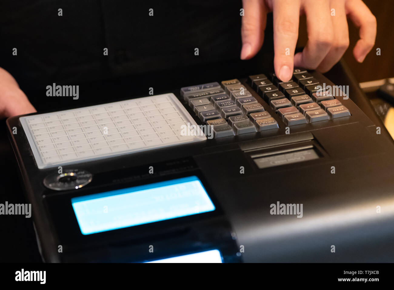 cash register installed on counter for accepting order from customer