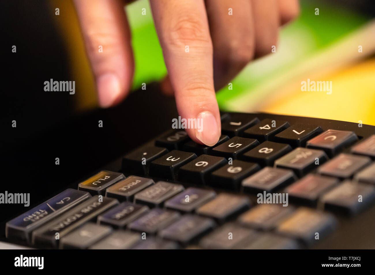 cash register installed on counter for accepting order from customer.sales man entering amount