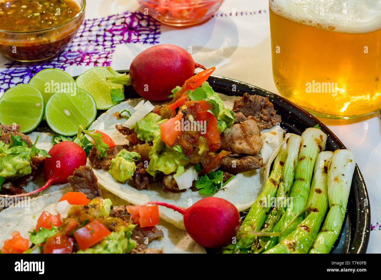 Tijuana tacos, carne asada with radishes, limes, spring onions and