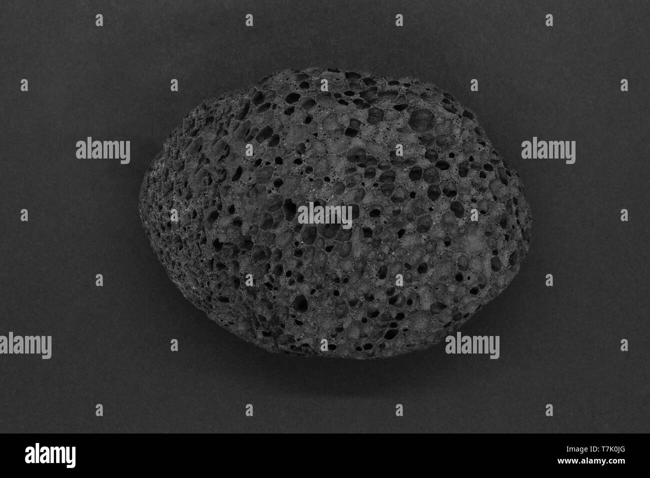 Black pumice stone for spa on grey matt background Stock Photo