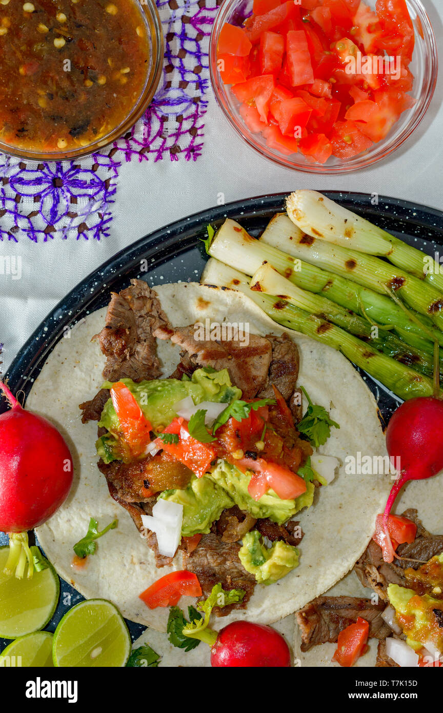 Tijuana tacos, carne asada with radishes, limes, spring onions and