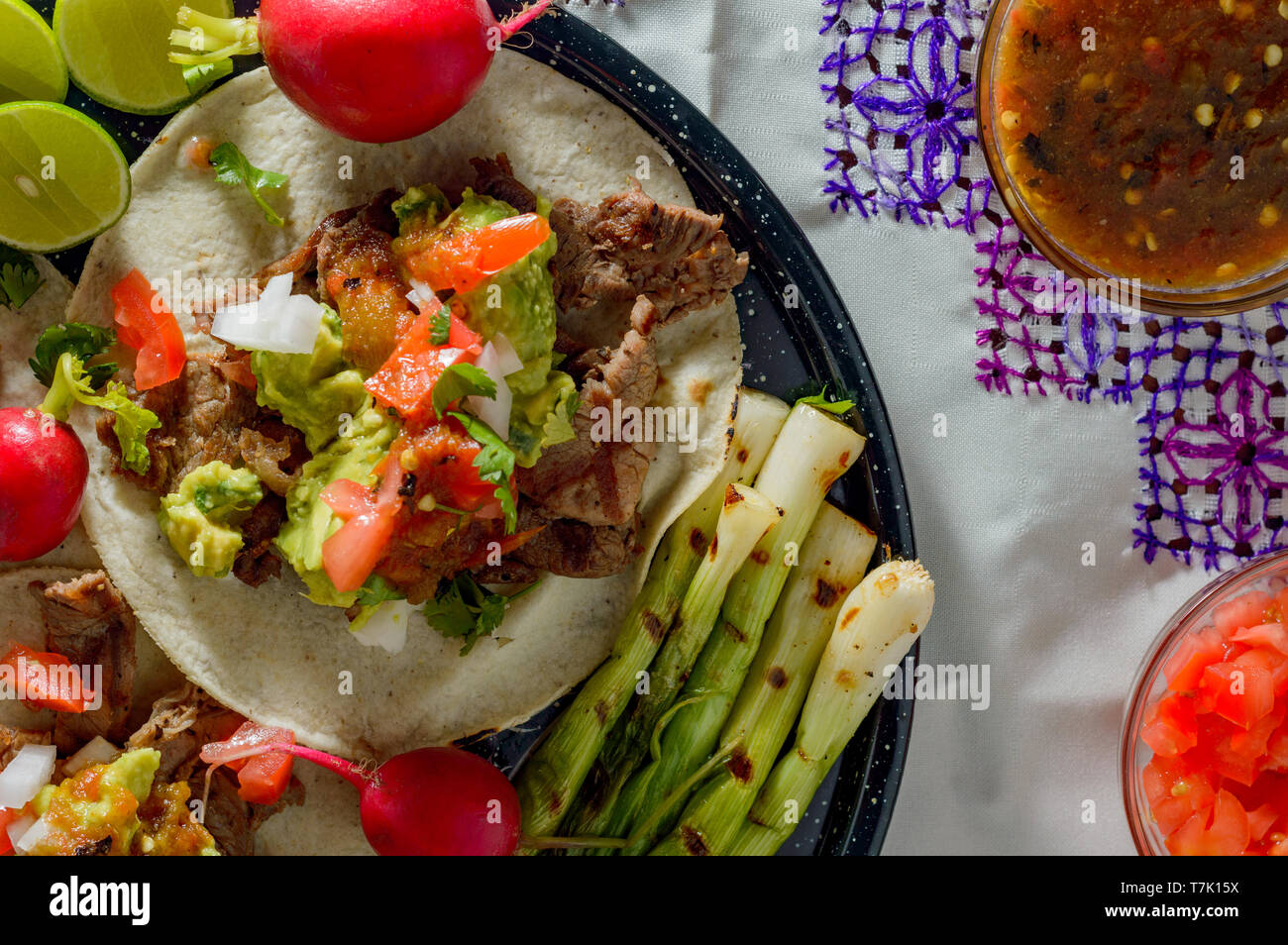 Tijuana tacos, carne asada with radishes, limes, spring onions and