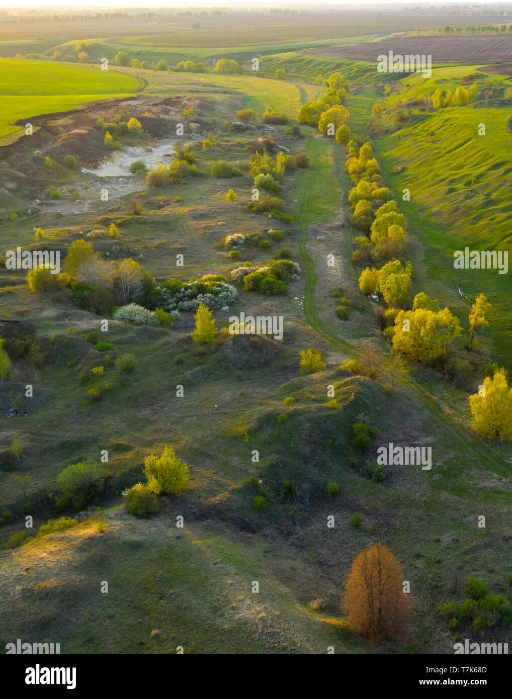 Spring fields, meadows, ravines at sunset from the quadrocopter Stock Photo